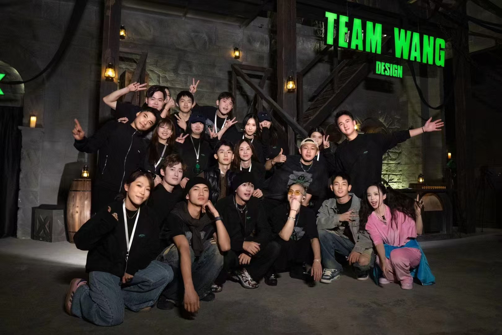 A group photograph outside a TEAM WANG DESIGN venue