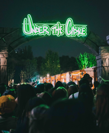 Under the Castle entrance arch and visitors at night